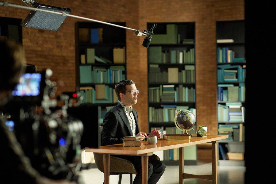 A camera rolling on Matthew Vines at the desk