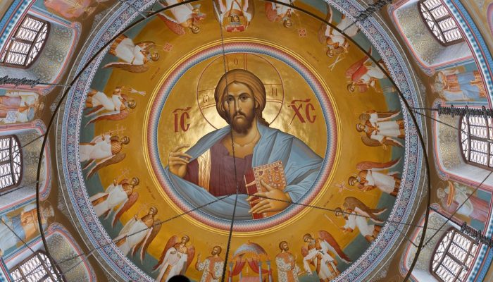 Vibrant fresco of a haloed central figure surrounded by cherubic angels